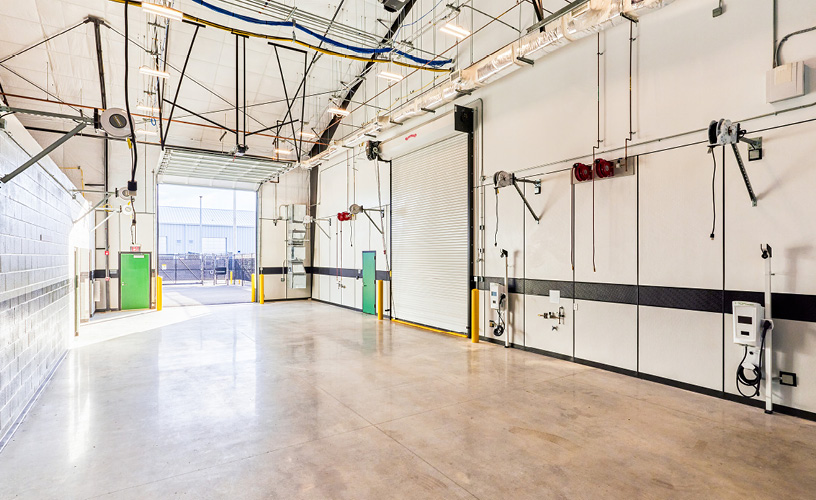 Interior shot of a Workshop Bay with the large garage door opened and the abutting bay door closed