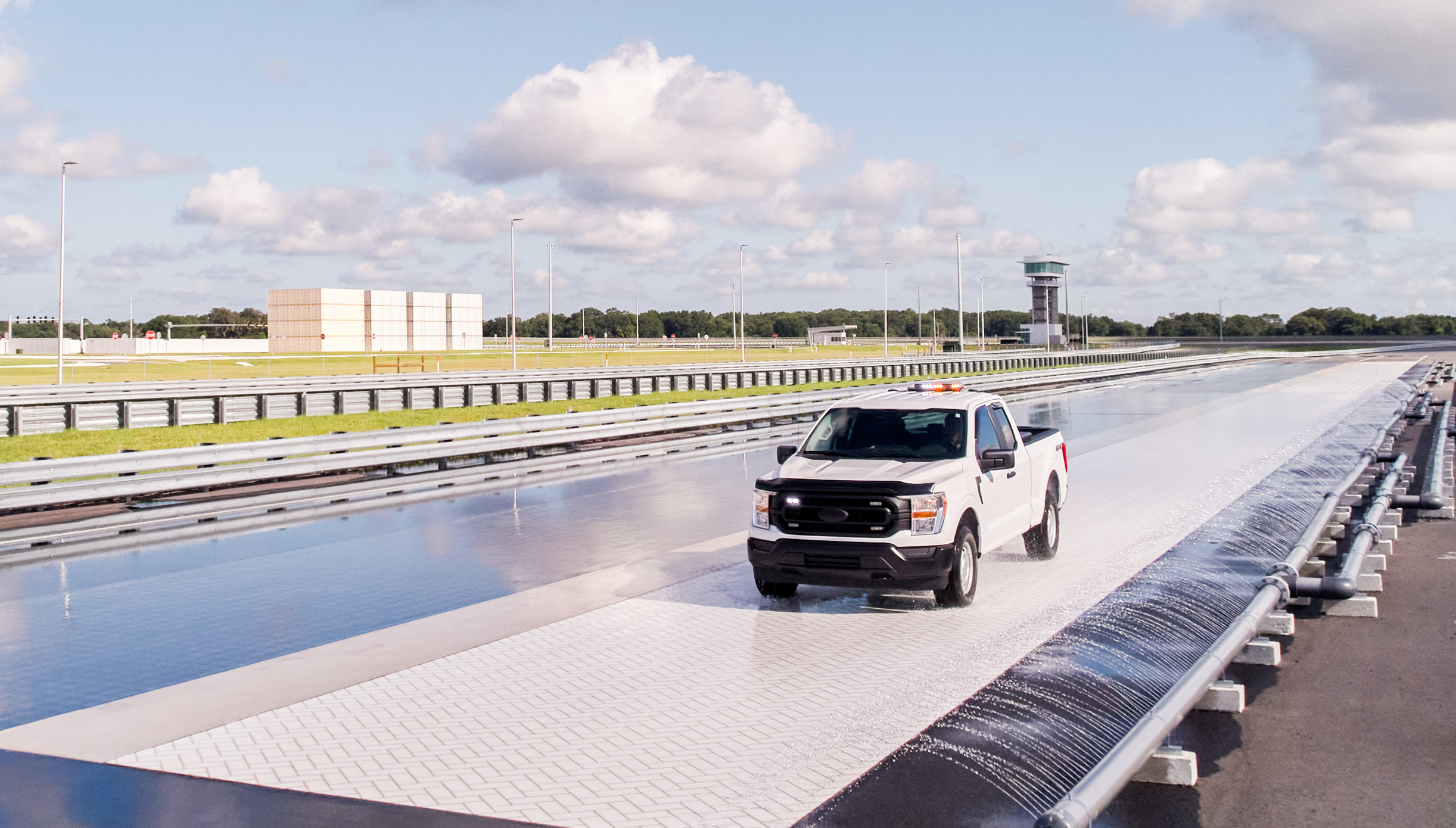 White truck driving on the Wet Test Track