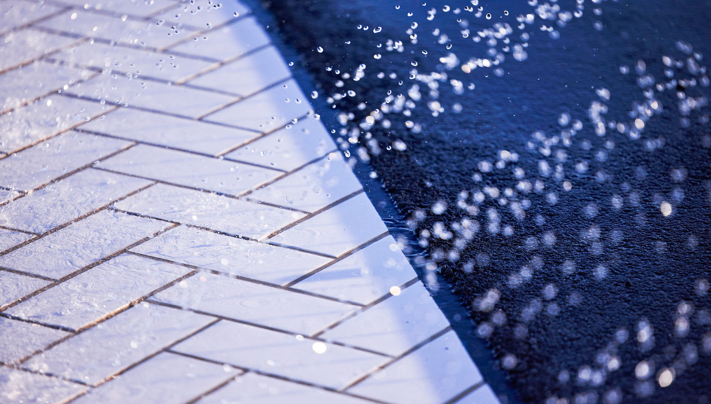 Close-up shot of the water falling on the pavement of the Wet Test Track