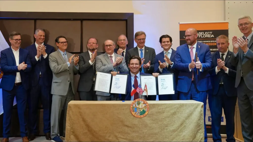 Governor DeSantis signing SB 1662 at the Florida Activation Event in Paris