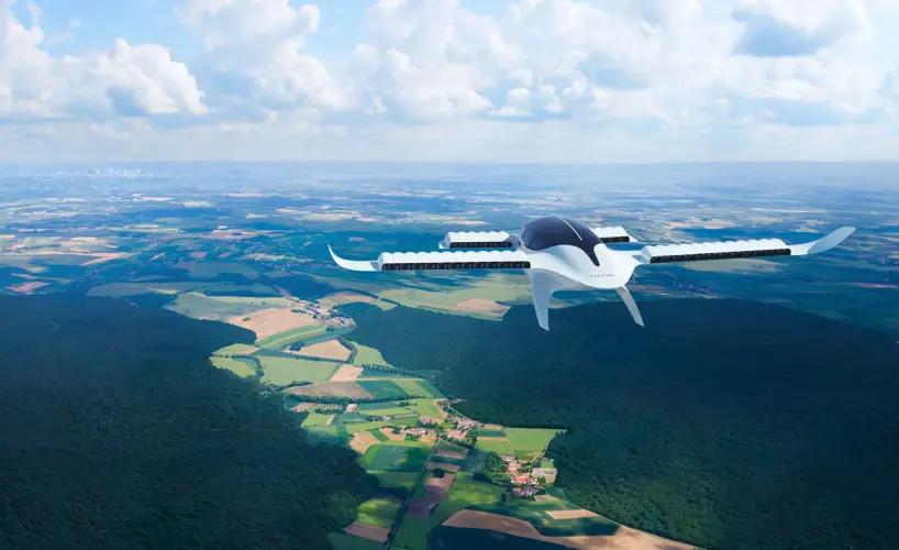 An eVTOL flies with the horizon in the background.