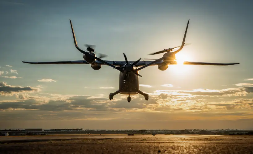Advanced eVTOL aircraft lifting off during sunset test flight