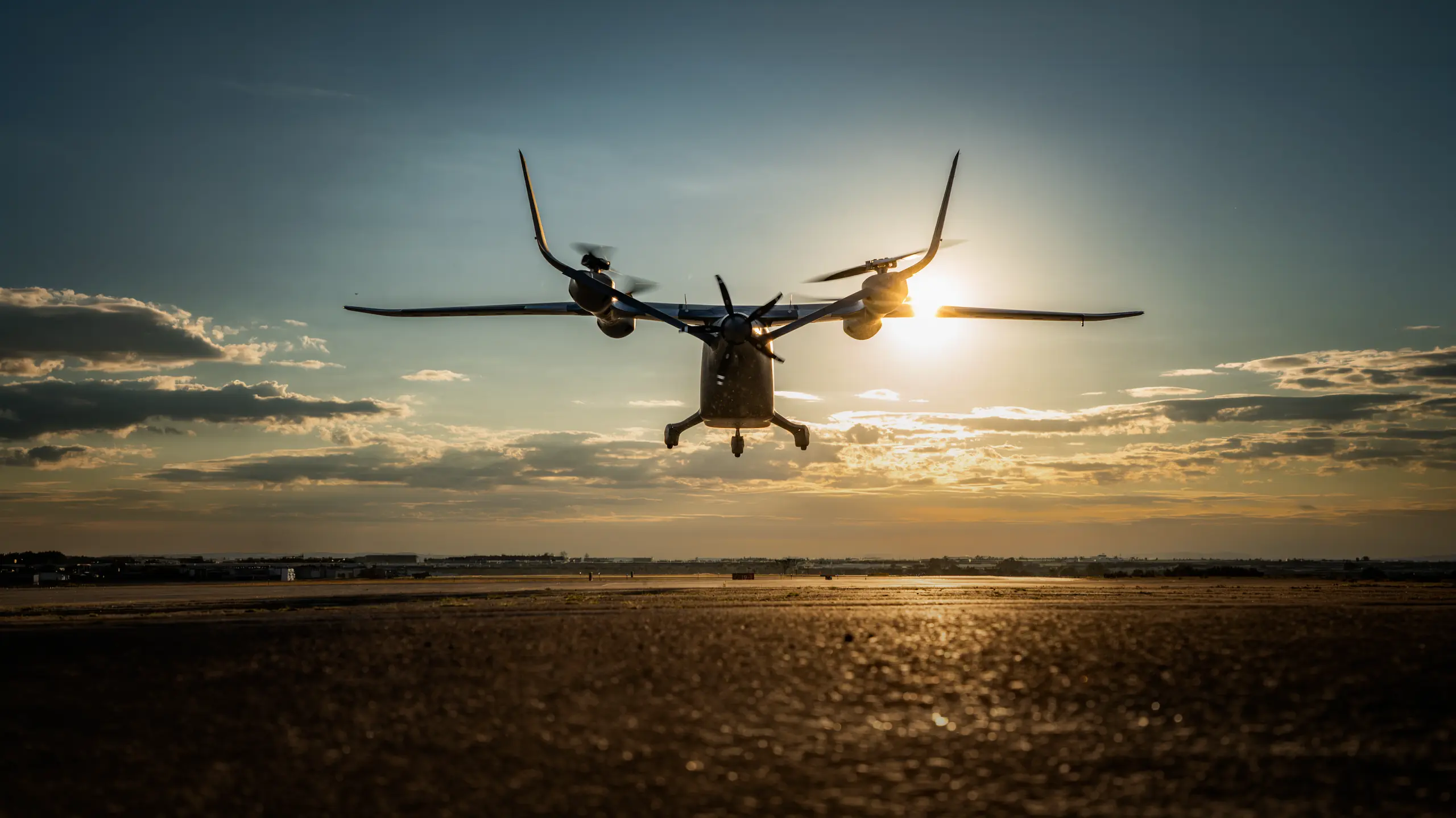 Play Video about Advanced eVTOL aircraft lifting off during sunset test flight