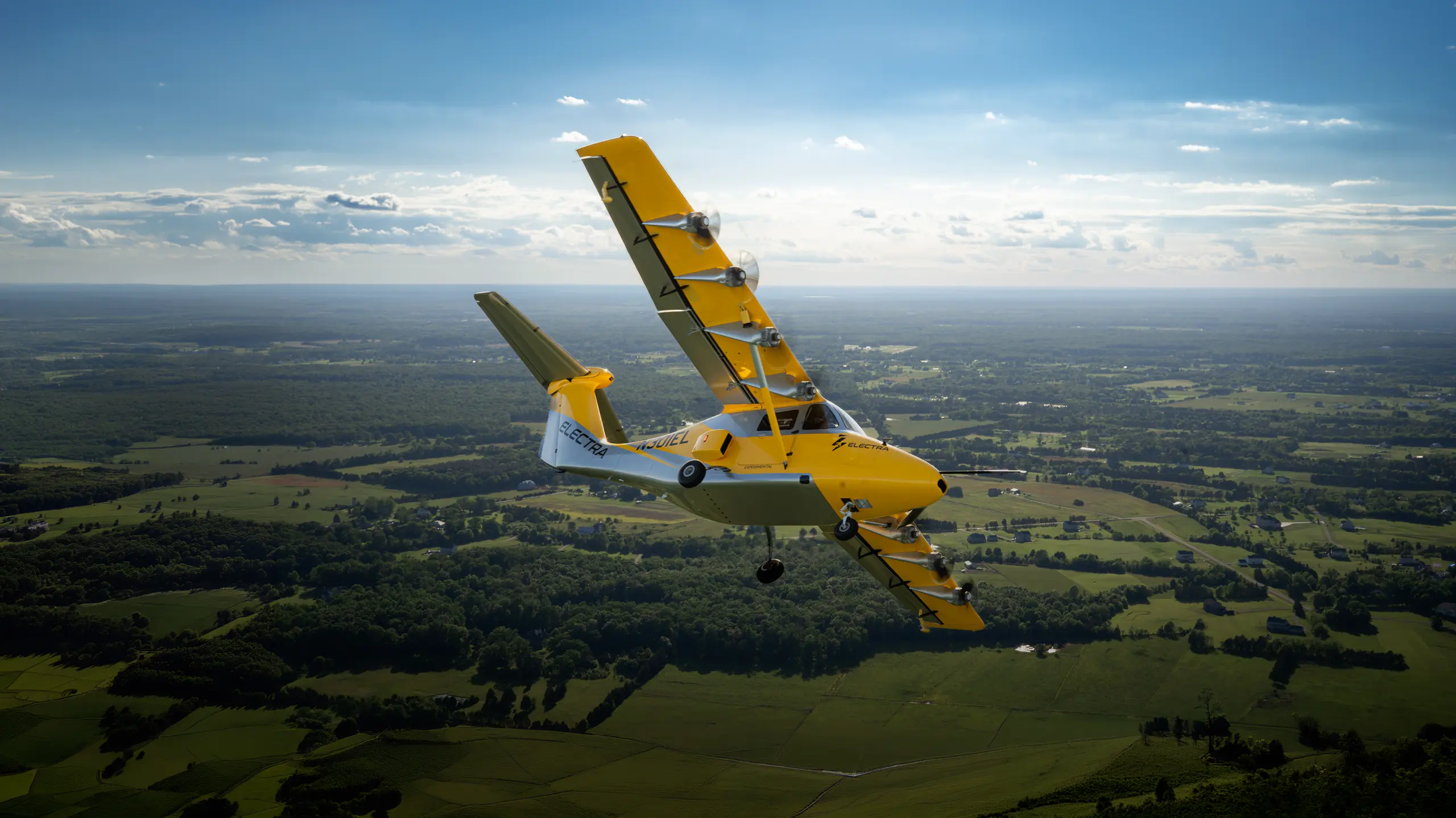 Play Video about Distributed electric propulsion research aircraft flying over rural landscape
